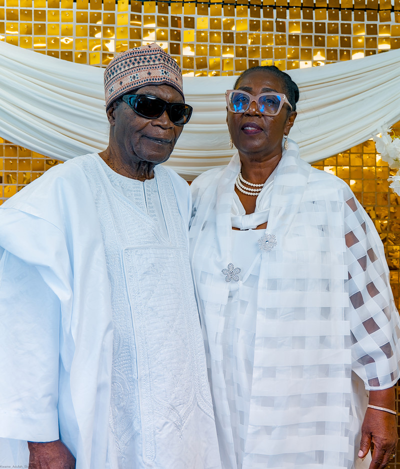 The celebrant and his wife side by side at the photo wall