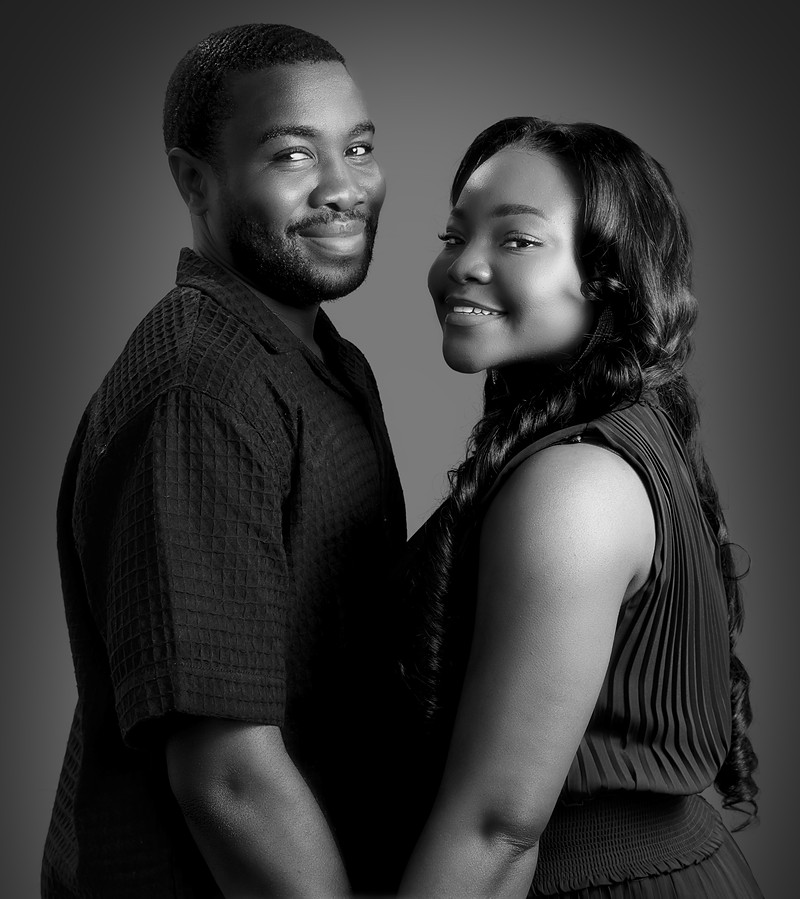 Black and white portrait of the engaged couple, cheek to cheek